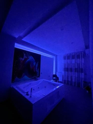 a dark room with a large bath tub in a room at COLOMBO SUITE in Cassino