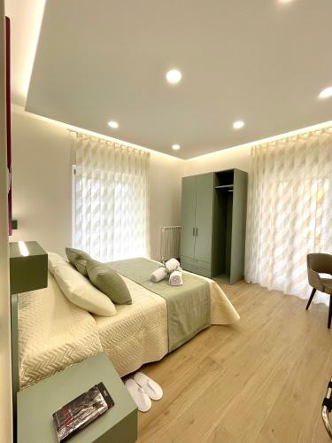 a bedroom with a large bed with two stuffed animals on it at COLOMBO SUITE in Cassino
