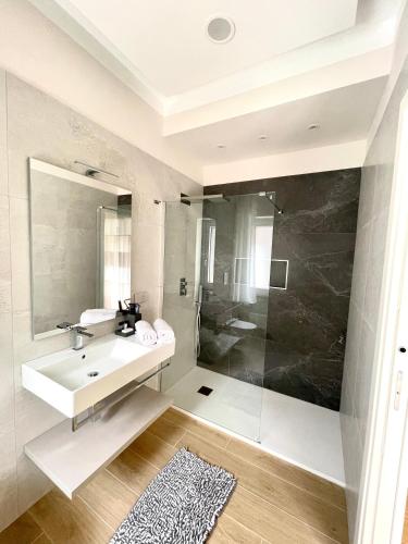 a bathroom with a sink and a shower at COLOMBO SUITE in Cassino