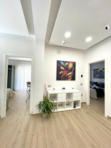 a white living room with a painting on the wall at COLOMBO SUITE in Cassino