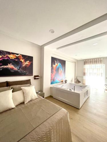 a bedroom with a large bed and a bath tub at COLOMBO SUITE in Cassino