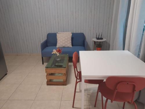 a living room with a blue couch and a table at J. B Apartamentos in Santo Domingo
