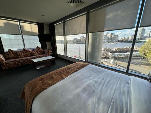 a bedroom with a bed and a view of the water at Rafayel Hotel & Spa in London