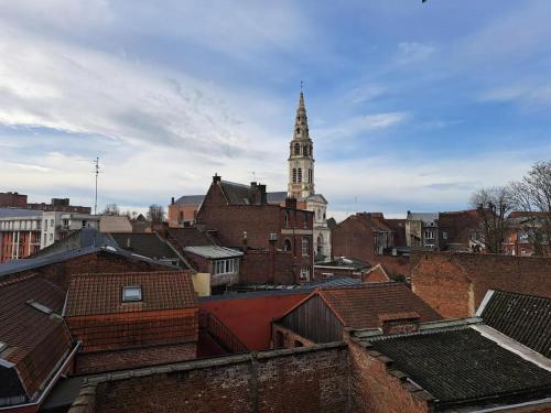 a view of a city with a clock tower at T3 en hyper-centre métro à 2 pas in Tourcoing