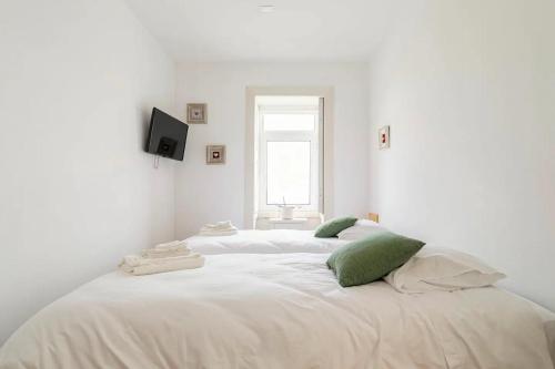 Ένα ή περισσότερα κρεβάτια σε δωμάτιο στο Cosy house for Surf & Beach