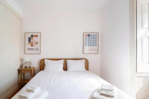 a bedroom with a white bed with two white pillows at Cosy house for Surf & Beach in Esmoriz