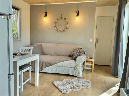 a living room with a couch and a table at Les gîtes de L'Isle Jourdain in Pujaudran