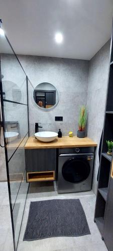 a bathroom with a sink and a mirror at Apartmán Porte in Košice