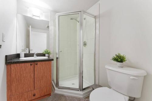 a bathroom with a shower and a toilet and a sink at Fabulous 2Bdr Duplex in Yaletown in Vancouver