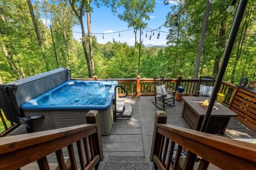 a hot tub on a deck with trees at Moonshine Overlook in Blue Ridge