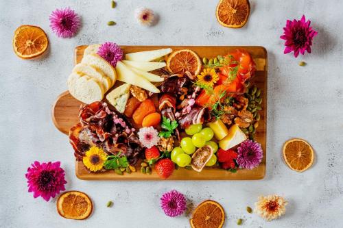 a plate of food with fruits and vegetables on a table at AC Hotel by Marriott Kuantan in Kuantan