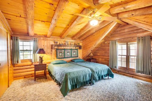 1 dormitorio con 1 cama y ventilador de techo en Waterfront Livingston Log Cabin with Private Dock!, en Blanchard