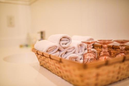 a basket of towels on a counter in a bathroom at My Rosegarden Guest Rooms in San Francisco