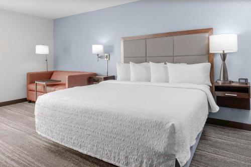 a hotel room with a large bed and a chair at Hampton Inn Sarasota I-75 Bee Ridge in Sarasota