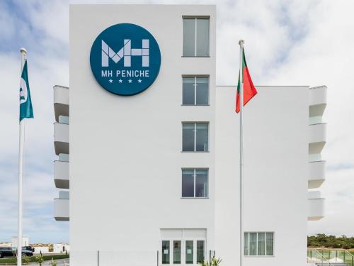 a building with the ministry of manpower and flags at MH Peniche in Peniche