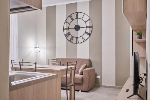a kitchen with a chair and a clock on the wall at Cristina Tuscany Holiday in Poggibonsi