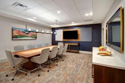 a conference room with a long table and chairs at Hilton Garden Inn Terre Haute in Terre Haute