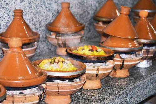 a group of vases with food in them on a table at Luxueux & Haut Standing OceanSwing Stay Taghazout Bay in Agadir
