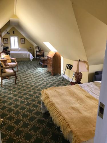 a attic bedroom with a bed and a desk at My Rosegarden Guest Rooms in San Francisco