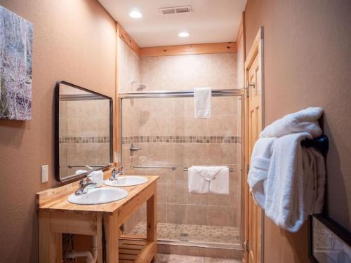 y baño con ducha, lavabo y espejo. en Elegant Elite Estate By Ghosal Luxury Lodging, en Pigeon Forge