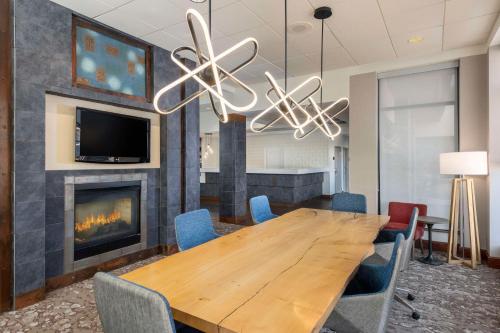 a dining room with a table and a fireplace at Hilton Garden Inn Scottsdale North/Perimeter Center in Scottsdale