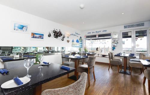 a dining room with tables and chairs in a restaurant at De L'Etang in Saint Helier Jersey