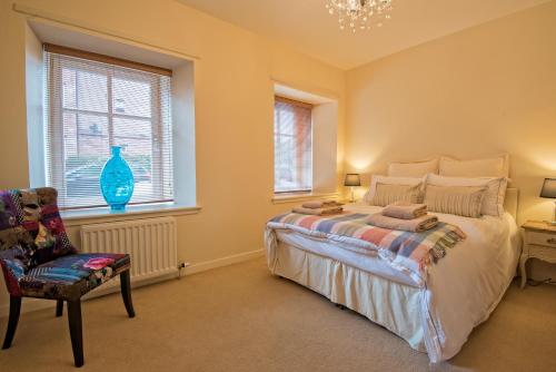 a bedroom with a bed and a chair and a window at The Ice House in Edinburgh