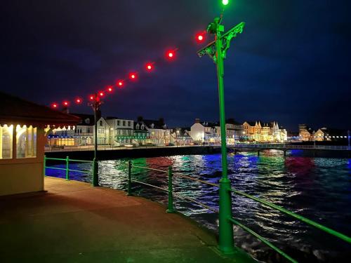 a cross on a pole with red lights at night at De L'Etang in Saint Helier Jersey