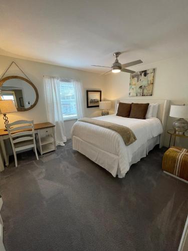 a bedroom with a bed and a table and a mirror at The Royal Room at Galleria in Houston