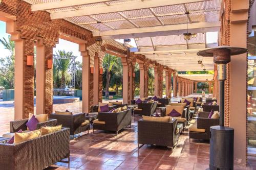 a lobby of a resort with tables and chairs at Barceló Palmeraie Oasis Resort in Marrakech