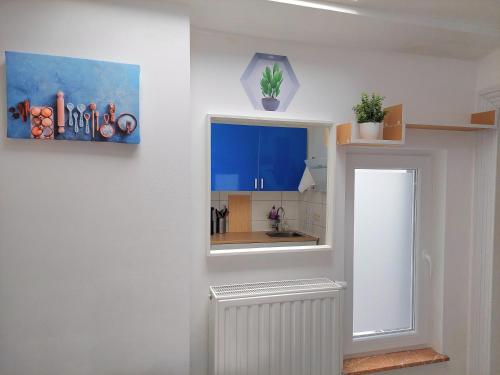 a kitchen with a window and a white radiator at Maison LYDIE - Meublé de vacances 3 étoiles in Charleroi