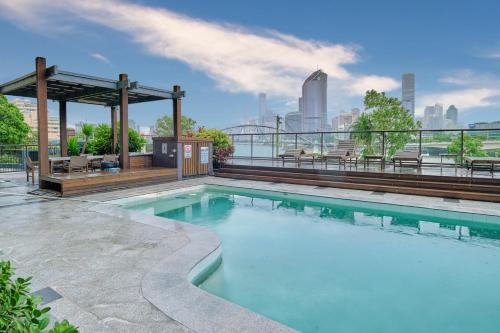 a swimming pool with a view of the city at River Plaza Apartments Brisbane in Brisbane