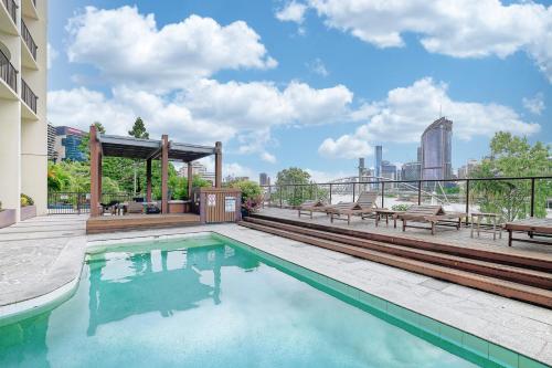 a swimming pool on a building with a view of the city at River Plaza Apartments Brisbane in Brisbane