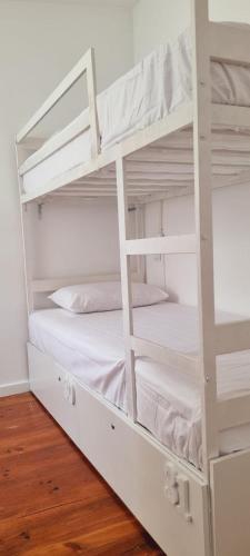 a white bunk bed in a room at Owls Hostel Ribeiro in Porto