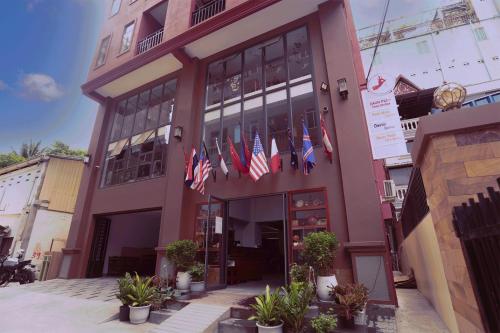a building with several american flags in front of it at Daun Penh Palace Boutique in Phnom Penh