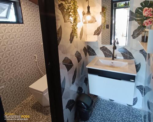 a bathroom with a sink and a toilet at Funtasea Hotel and Beach Resort in Iba