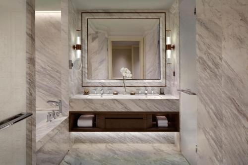 a bathroom with a sink and a mirror at The Ritz-Carlton, Harbin in Harbin