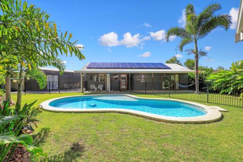 a house with a swimming pool in the yard at The Hideaway in Bargara