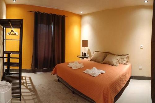 1 dormitorio con 1 cama con 2 toallas en Casa imperial Estancia Verde, Biotopo del Quetzal, en Purulhá