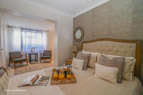 a bedroom with a large bed with a table and chairs at Large villa sleeping 8 under 5 minute walk to beach in Caister-on-Sea