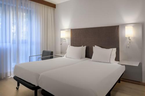 1 cama blanca grande en una habitación de hotel en AC Hotel by Marriott Pisa, en Pisa