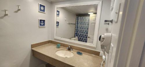 a bathroom with a sink and a mirror at Oceanfront Paradise/Waterpark/pools/lazyriver in Myrtle Beach