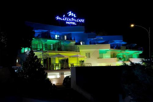 a building with a neon sign on it at night at Hotel Miramare in Gallipoli
