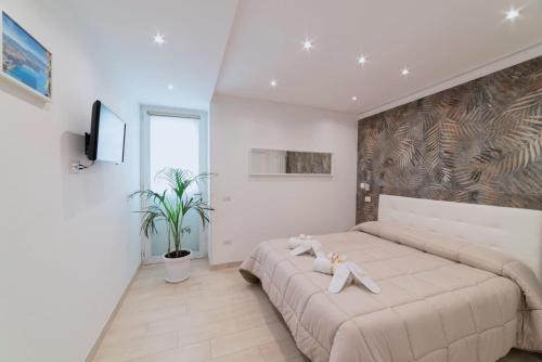 a bedroom with a large bed with two teddy bears on it at Stone House Michelle in Torre Annunziata