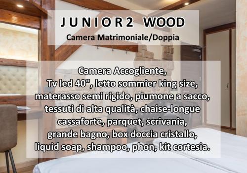 a bedroom with a sign that reads junora wood at Garden Wellness Hotel S in Andalo