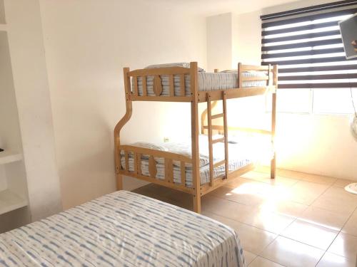a bedroom with two bunk beds in a room at Pangora, habitación privada de Flor de Lis Beach House in Playas