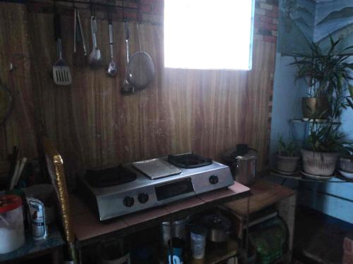 a kitchen with a stove top oven on a table at ARSIAM Transient Room in Baguio