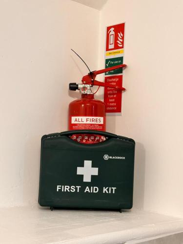 a first aid kit sitting on a shelf next to a first aid kitktopktop at Kriss house in Bristol
