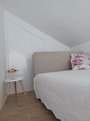 a bedroom with a bed and a side table at ZIL - Studio Apartment City Center in Zagreb