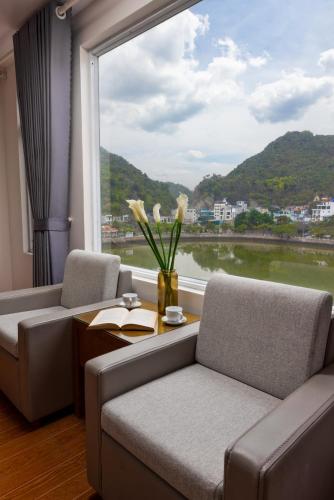 a room with two couches and a window with a view at Catba Central Hotel 2 in Cat Ba